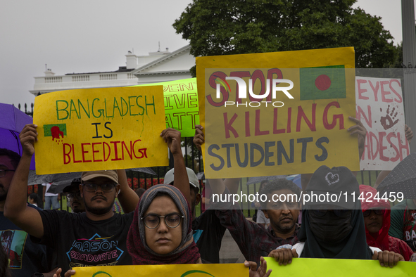 Demonstrators of the Bangladeshi community are displaying signs with the words ''Bangladesh is Bleeding, Stop Killing Students'' among other...