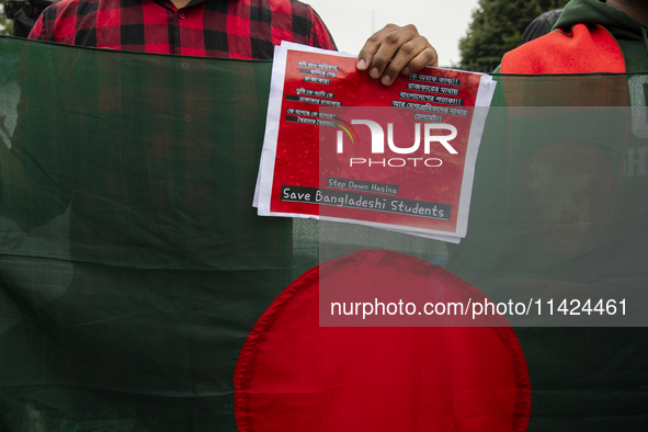 A demonstrator of the Bangladeshi community is holding a sign with the words ''Save Bangladeshi Students'' among other informative texts dur...