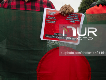 A demonstrator of the Bangladeshi community is holding a sign with the words ''Save Bangladeshi Students'' among other informative texts dur...