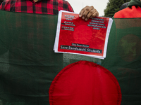 A demonstrator of the Bangladeshi community is holding a sign with the words ''Save Bangladeshi Students'' among other informative texts dur...