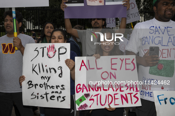 Demonstrators of the Bangladeshi community are displaying signs with the words ''All Eyes On Bangladeshi Students,'' among other informative...