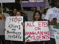 Demonstrators of the Bangladeshi community are displaying signs with the words ''All Eyes On Bangladeshi Students,'' among other informative...