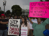 A demonstrator of the Bangladeshi community is holding a sign with the words ''Stop killing us by disconnecting the network & internet'' dur...