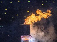 The fire tower of the opening ceremony is being lit on the Asilisi grassland in Hezhang county, Bijie, China, on July 20, 2024. (