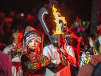 A sacred woman of the Yi ethnic group is escorting fire on the Asilisi grassland in Hezhang county, Bijie city, Southwest China's Guizhou pr...