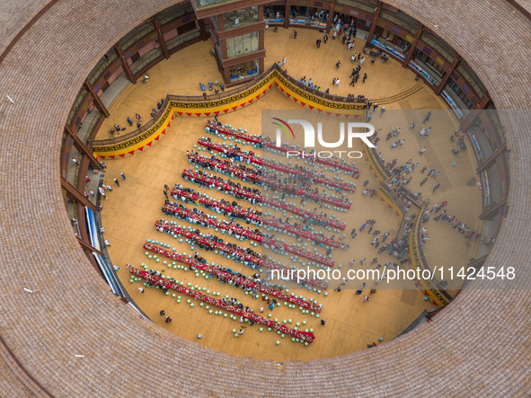 Tourists are enjoying a long table banquet on the Asilisi grassland in Hezhang county, Bijie city, Southwest China's Guizhou province, on Ju...