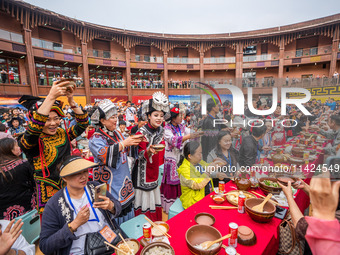 Tourists are enjoying a long table banquet on the Asilisi grassland in Hezhang county, Bijie city, Southwest China's Guizhou province, on Ju...