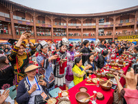 Tourists are enjoying a long table banquet on the Asilisi grassland in Hezhang county, Bijie city, Southwest China's Guizhou province, on Ju...