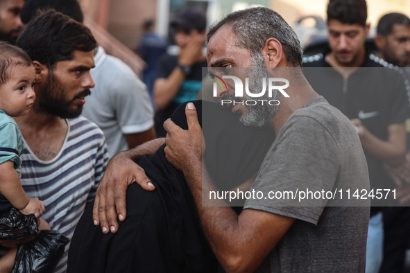 Relatives of the Palestinians, who are dying in Israeli attacks, are mourning at Al-Aqsa Martyr's Hospital in Deir al-Balah, Gaza, on July 2...