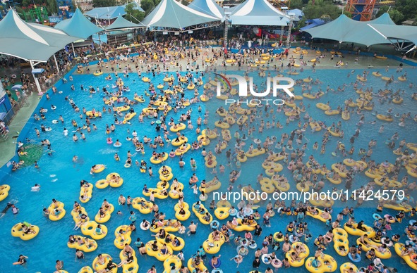 A large number of tourists are cooling off at a water park in Hangzhou, China, on July 21, 2024. 