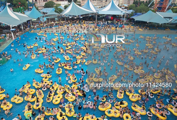 A large number of tourists are cooling off at a water park in Hangzhou, China, on July 21, 2024. 