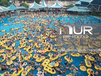 A large number of tourists are cooling off at a water park in Hangzhou, China, on July 21, 2024. (