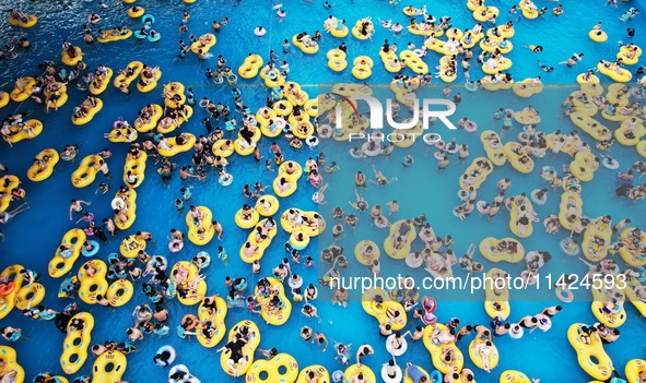 A large number of tourists are cooling off at a water park in Hangzhou, China, on July 21, 2024. 