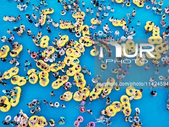 A large number of tourists are cooling off at a water park in Hangzhou, China, on July 21, 2024. (