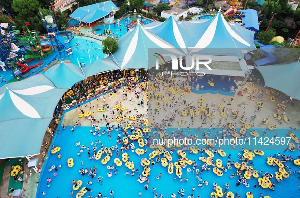 A large number of tourists are cooling off at a water park in Hangzhou, China, on July 21, 2024. 