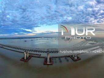 The steel deck pavement of the main channel bridge of the Changtai Yangtze River Bridge is under construction in Taixing, China, on July 21,...