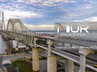 The steel deck pavement of the main channel bridge of the Changtai Yangtze River Bridge is under construction in Taixing, China, on July 21,...