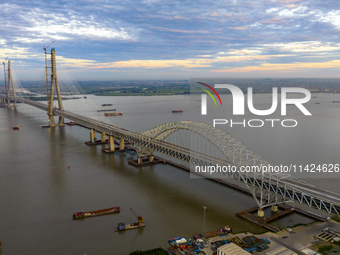 The steel deck pavement of the main channel bridge of the Changtai Yangtze River Bridge is under construction in Taixing, China, on July 21,...