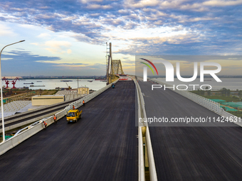 The steel deck pavement of the main channel bridge of the Changtai Yangtze River Bridge is under construction in Taixing, China, on July 21,...