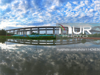 The steel deck pavement of the main channel bridge of the Changtai Yangtze River Bridge is under construction in Taixing, China, on July 21,...