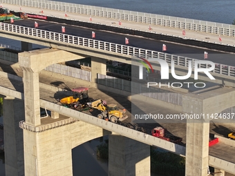 The steel deck pavement of the main channel bridge of the Changtai Yangtze River Bridge is under construction in Taixing, China, on July 21,...