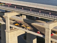 The steel deck pavement of the main channel bridge of the Changtai Yangtze River Bridge is under construction in Taixing, China, on July 21,...