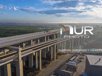 The steel deck pavement of the main channel bridge of the Changtai Yangtze River Bridge is under construction in Taixing, China, on July 21,...