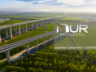 The steel deck pavement of the main channel bridge of the Changtai Yangtze River Bridge is under construction in Taixing, China, on July 21,...