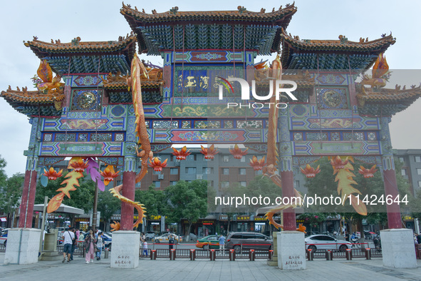 Tourists are enjoying the scenery of Saishang Old Street, the core area of the Saishang Old Street tourism and leisure district, in Hohhot,...