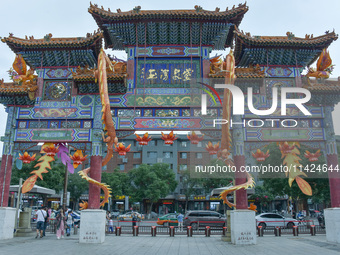 Tourists are enjoying the scenery of Saishang Old Street, the core area of the Saishang Old Street tourism and leisure district, in Hohhot,...