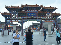 Tourists are enjoying the scenery of Saishang Old Street, the core area of the Saishang Old Street tourism and leisure district, in Hohhot,...