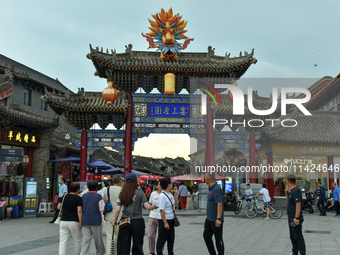 Tourists are enjoying the scenery of Saishang Old Street, the core area of the Saishang Old Street tourism and leisure district, in Hohhot,...