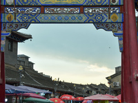 Tourists are enjoying the scenery of Saishang Old Street, the core area of the Saishang Old Street tourism and leisure district, in Hohhot,...