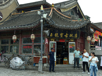 Tourists are enjoying the scenery of Saishang Old Street, the core area of the Saishang Old Street tourism and leisure district, in Hohhot,...