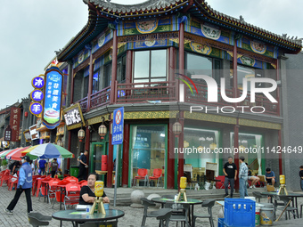 Tourists are enjoying the scenery of Saishang Old Street, the core area of the Saishang Old Street tourism and leisure district, in Hohhot,...