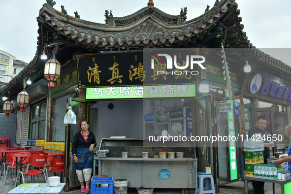 Tourists are enjoying the scenery of Saishang Old Street, the core area of the Saishang Old Street tourism and leisure district, in Hohhot,...