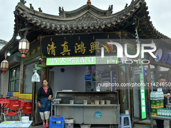 Tourists are enjoying the scenery of Saishang Old Street, the core area of the Saishang Old Street tourism and leisure district, in Hohhot,...