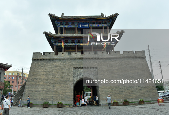 Tourists are enjoying the scenery of Saishang Old Street, the core area of the Saishang Old Street tourism and leisure district, in Hohhot,...