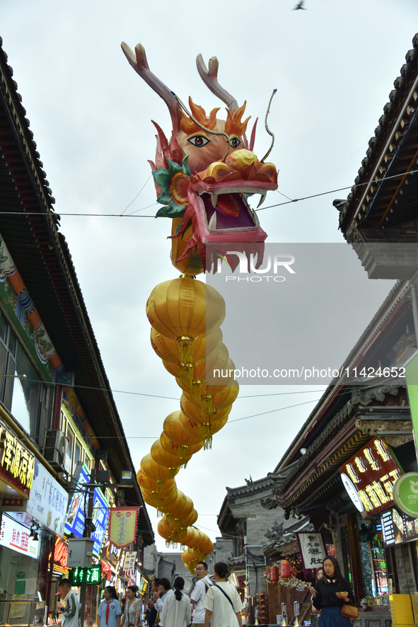 Tourists are enjoying the scenery of Saishang Old Street, the core area of the Saishang Old Street tourism and leisure district, in Hohhot,...