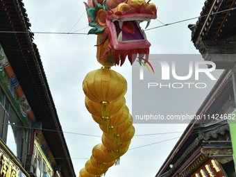 Tourists are enjoying the scenery of Saishang Old Street, the core area of the Saishang Old Street tourism and leisure district, in Hohhot,...