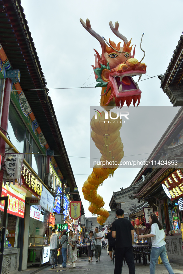 Tourists are enjoying the scenery of Saishang Old Street, the core area of the Saishang Old Street tourism and leisure district, in Hohhot,...