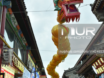 Tourists are enjoying the scenery of Saishang Old Street, the core area of the Saishang Old Street tourism and leisure district, in Hohhot,...