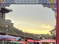 Tourists are enjoying the scenery of Saishang Old Street, the core area of the Saishang Old Street tourism and leisure district, in Hohhot,...