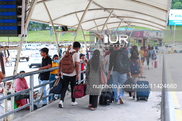 Nepali students are exiting the terminal of Tribhuvan International Airport upon arriving back in Kathmandu, Nepal, from violence-hit Bangla...