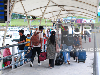 Nepali students are exiting the terminal of Tribhuvan International Airport upon arriving back in Kathmandu, Nepal, from violence-hit Bangla...