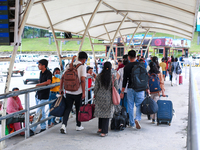 Nepali students are exiting the terminal of Tribhuvan International Airport upon arriving back in Kathmandu, Nepal, from violence-hit Bangla...