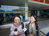 Sadikshya Basent (L), a Nepali student who is returning from violence-hit Bangladesh, is speaking to the media upon arriving at Tribhuvan In...