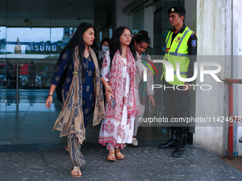 Krishpa Rai (center) along with other Nepali students are exiting the terminal of Tribhuvan International Airport upon arriving back in Kath...