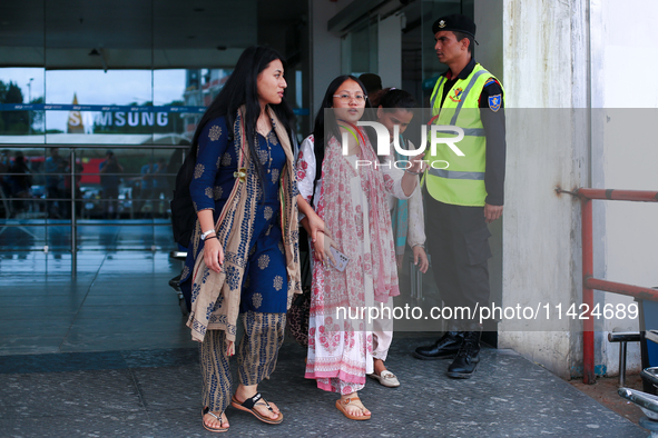 Krishpa Rai (center) along with other Nepali students are exiting the terminal of Tribhuvan International Airport upon arriving back in Kath...