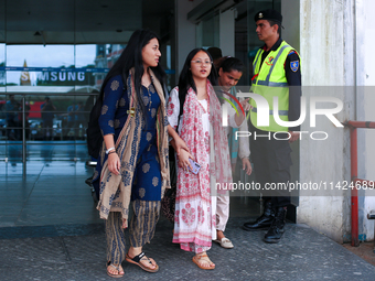 Krishpa Rai (center) along with other Nepali students are exiting the terminal of Tribhuvan International Airport upon arriving back in Kath...